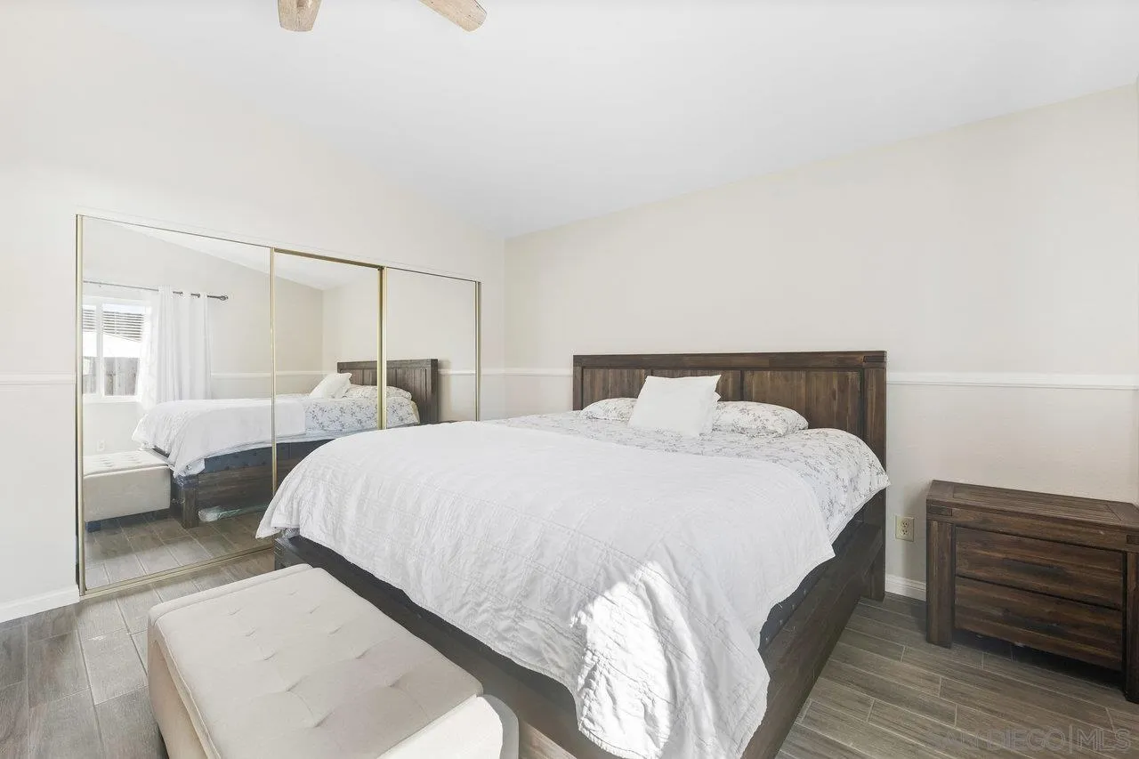 607 Maybritt Circle San Marcos, CA 92069 - Photo 32 of 38 a bedroom with a bed and wooden floor