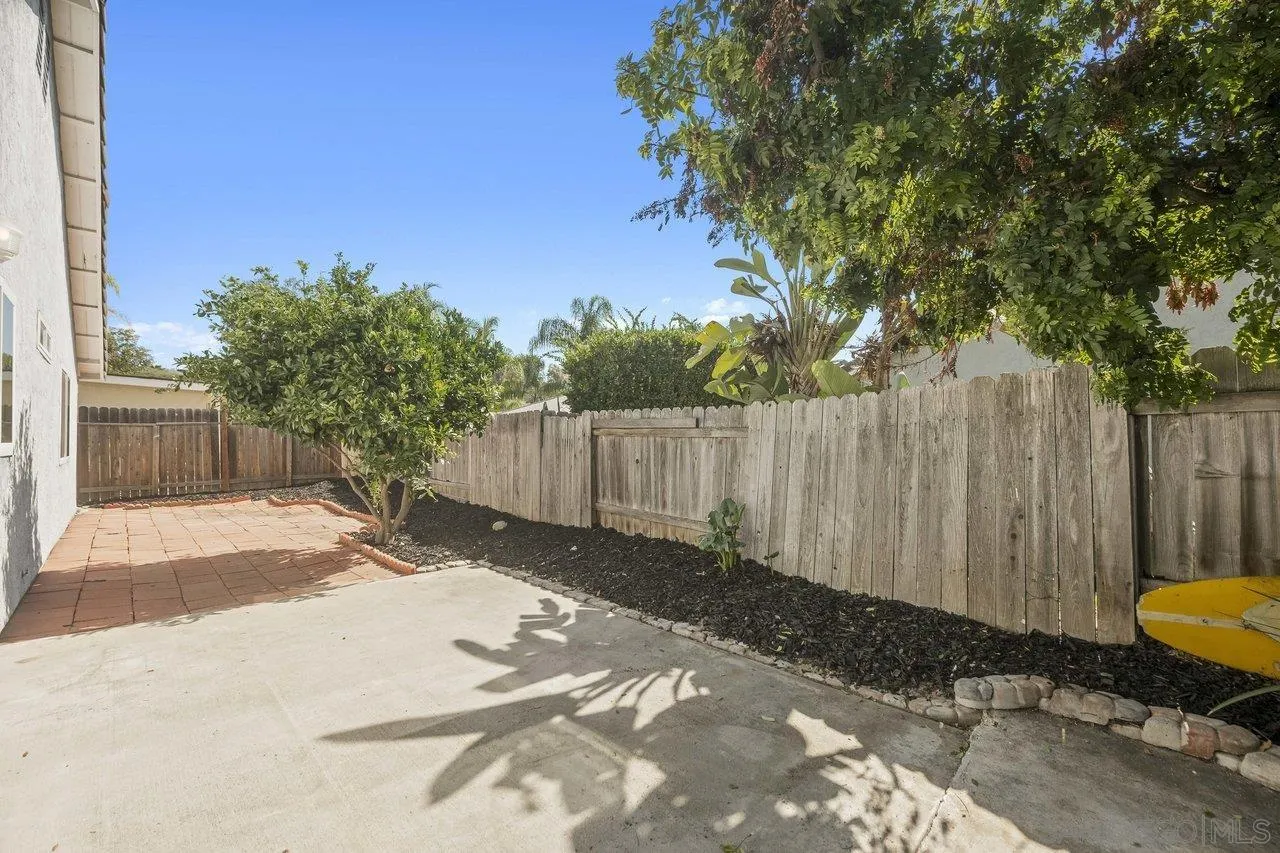 607 Maybritt Circle San Marcos, CA 92069 - Photo 33 of 38 a view of a backyard with wooden fence and a couple of water