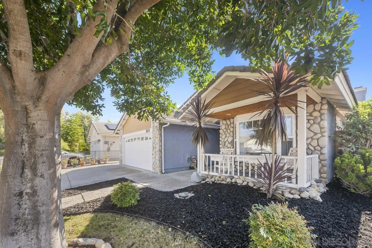 607 Maybritt Circle San Marcos, CA 92069 - Photo 4 of 38 a view of a house with a small yard plants and a large tree