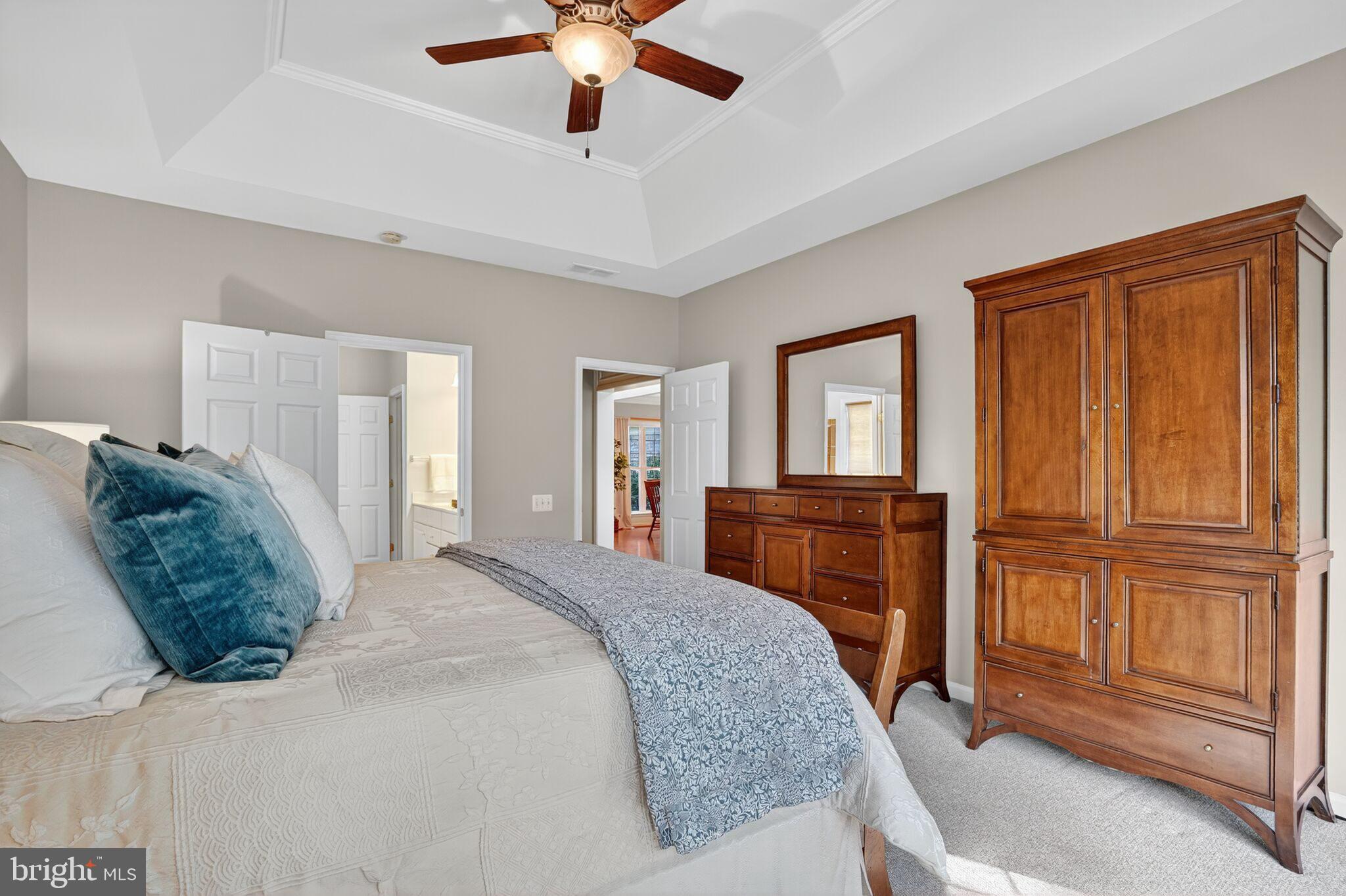 8157 American Holly Road Lorton, VA 22079 - Photo 13 of 48 a bedroom with a large bed and a chandelier