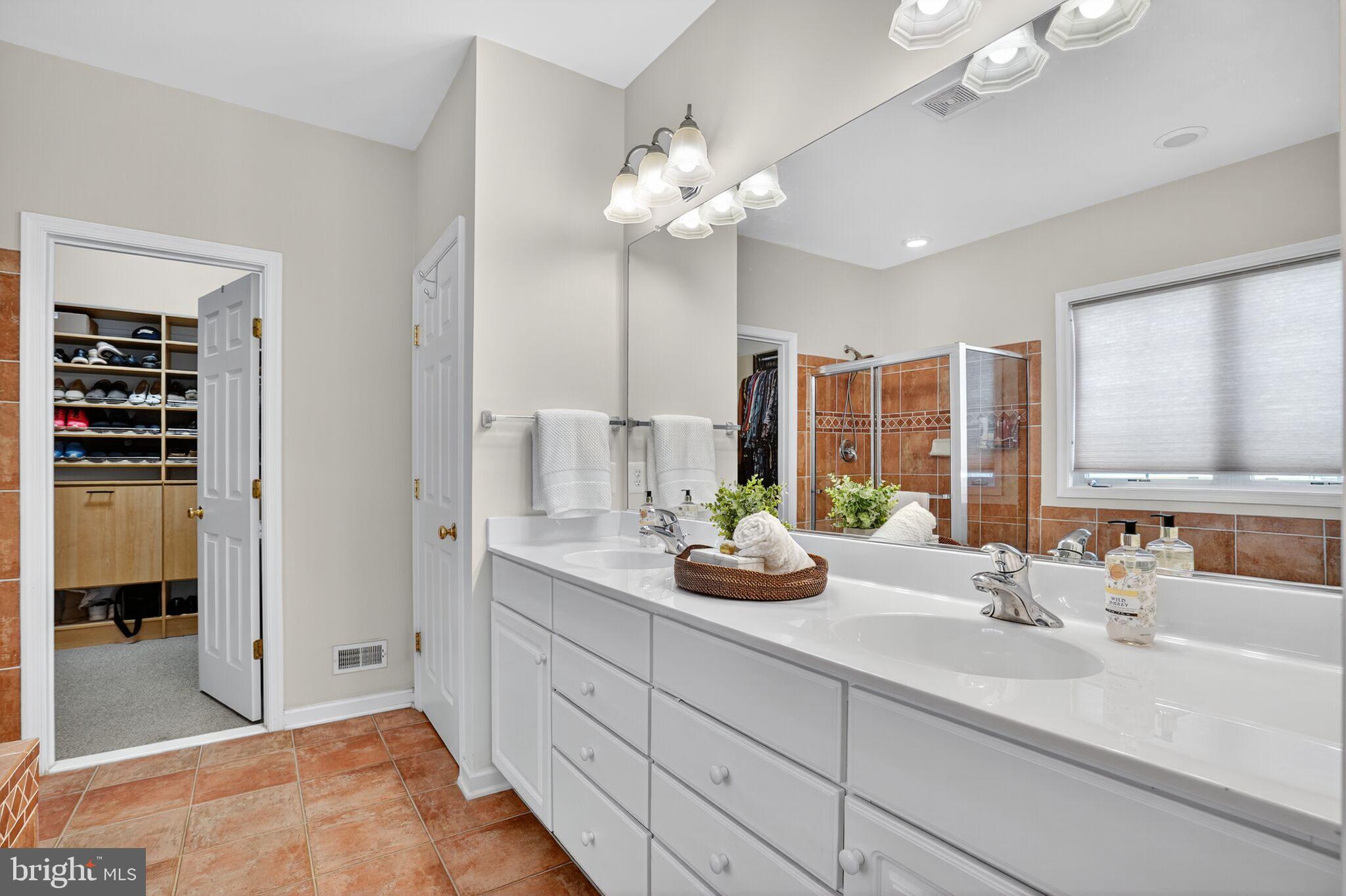 8157 American Holly Road Lorton, VA 22079 - Photo 15 of 48 a bathroom with a double vanity sink and a mirror