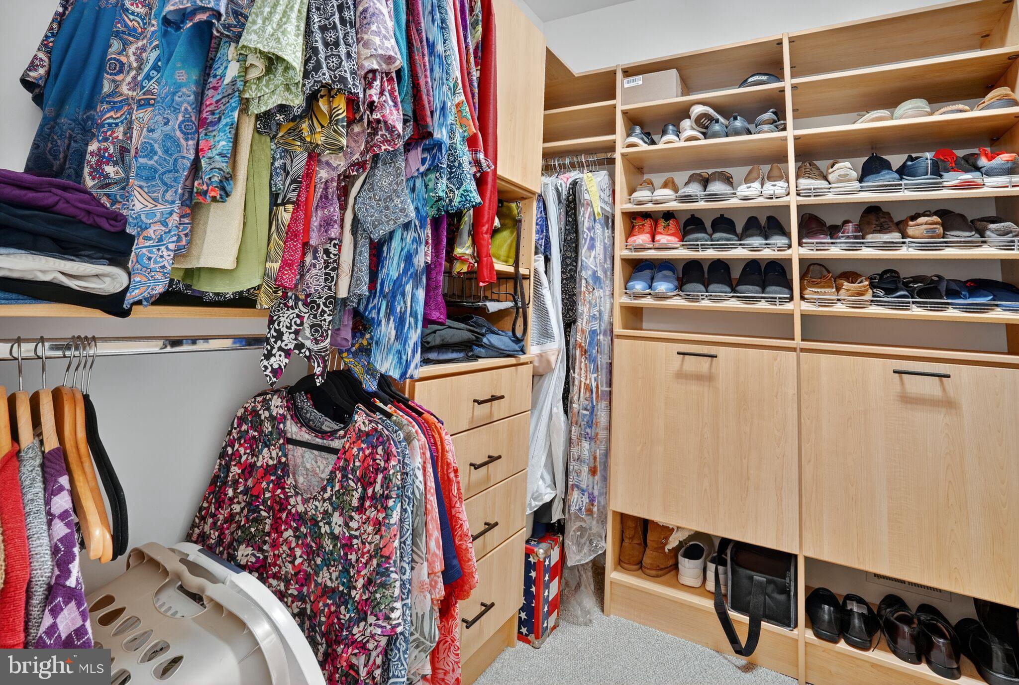 8157 American Holly Road Lorton, VA 22079 - Photo 16 of 48 a view of walk in closet with clothes and shoes