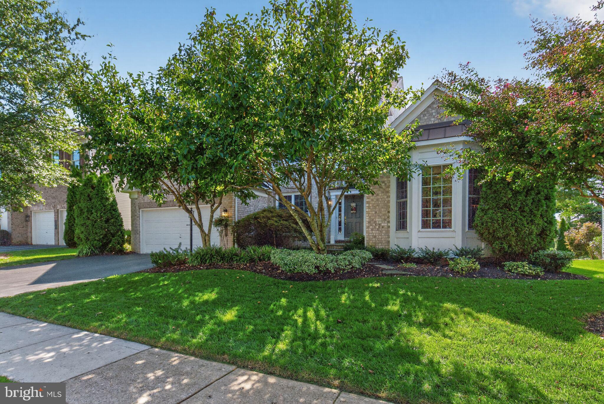 8157 American Holly Road Lorton, VA 22079 - Photo 2 of 48 a front view of a house with a garden