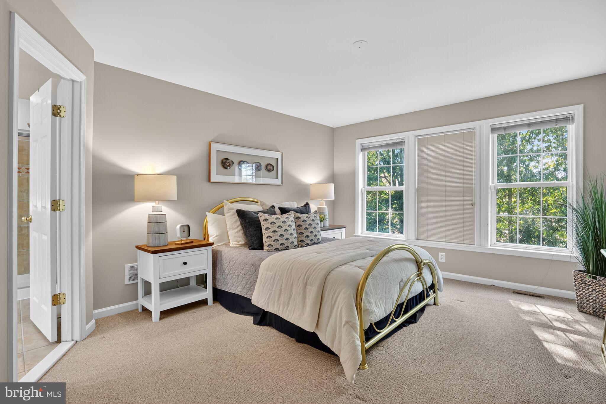 8157 American Holly Road Lorton, VA 22079 - Photo 27 of 48 a bed sitting in a bedroom next to a window