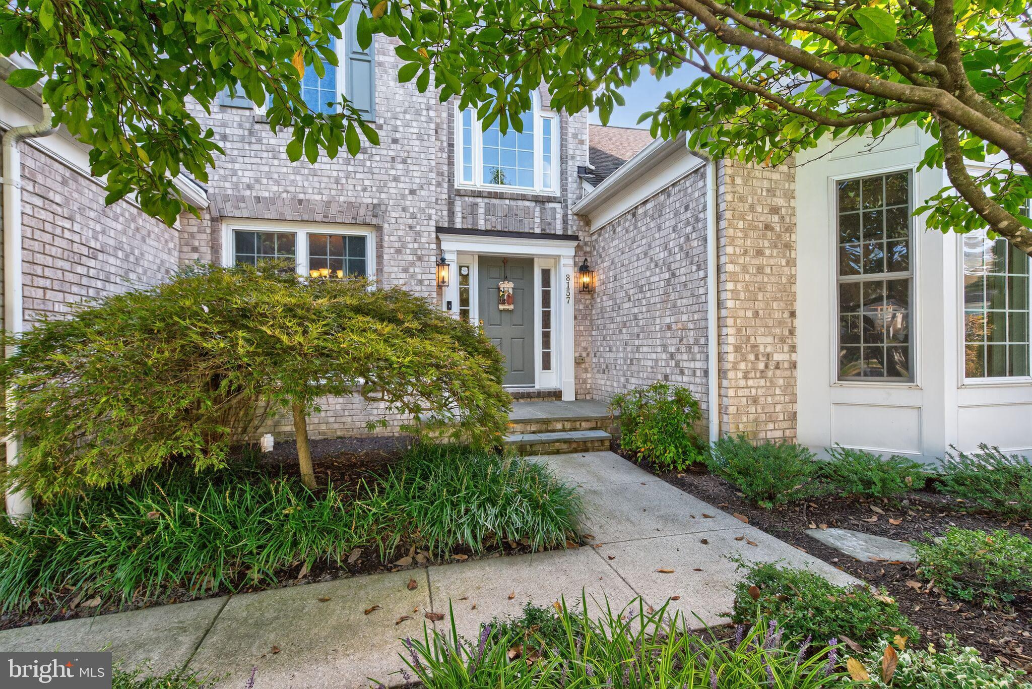 8157 American Holly Road Lorton, VA 22079 - Photo 3 of 48 a front view of a house with a garden