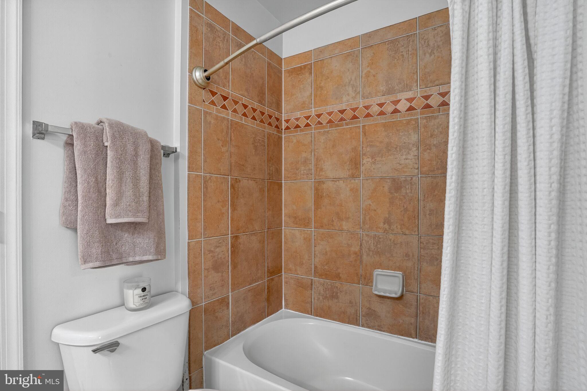 8157 American Holly Road Lorton, VA 22079 - Photo 31 of 48 a bathroom with a shower a toilet and a sink