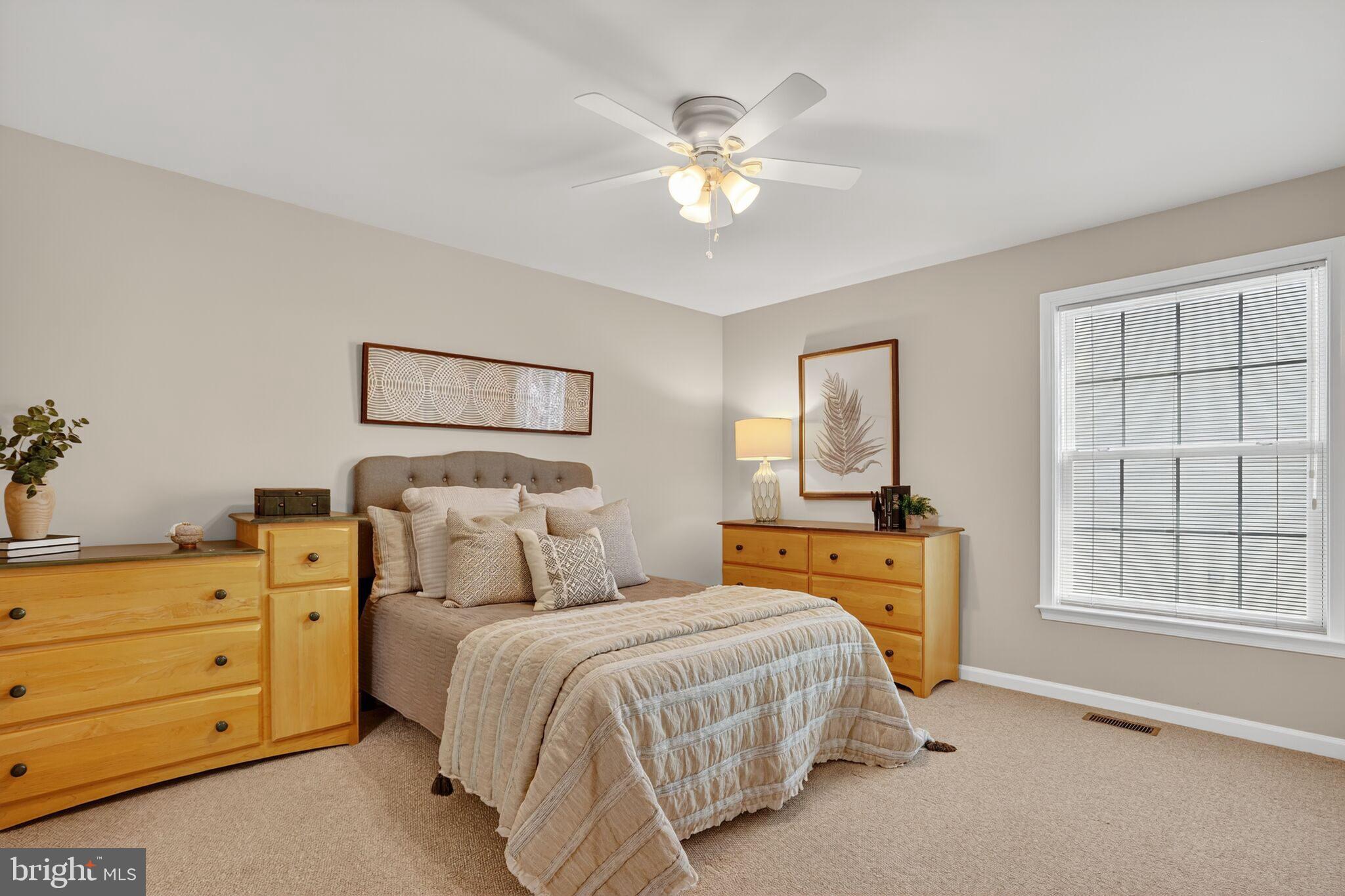 8157 American Holly Road Lorton, VA 22079 - Photo 32 of 48 a bedroom with a large bed and a chandelier