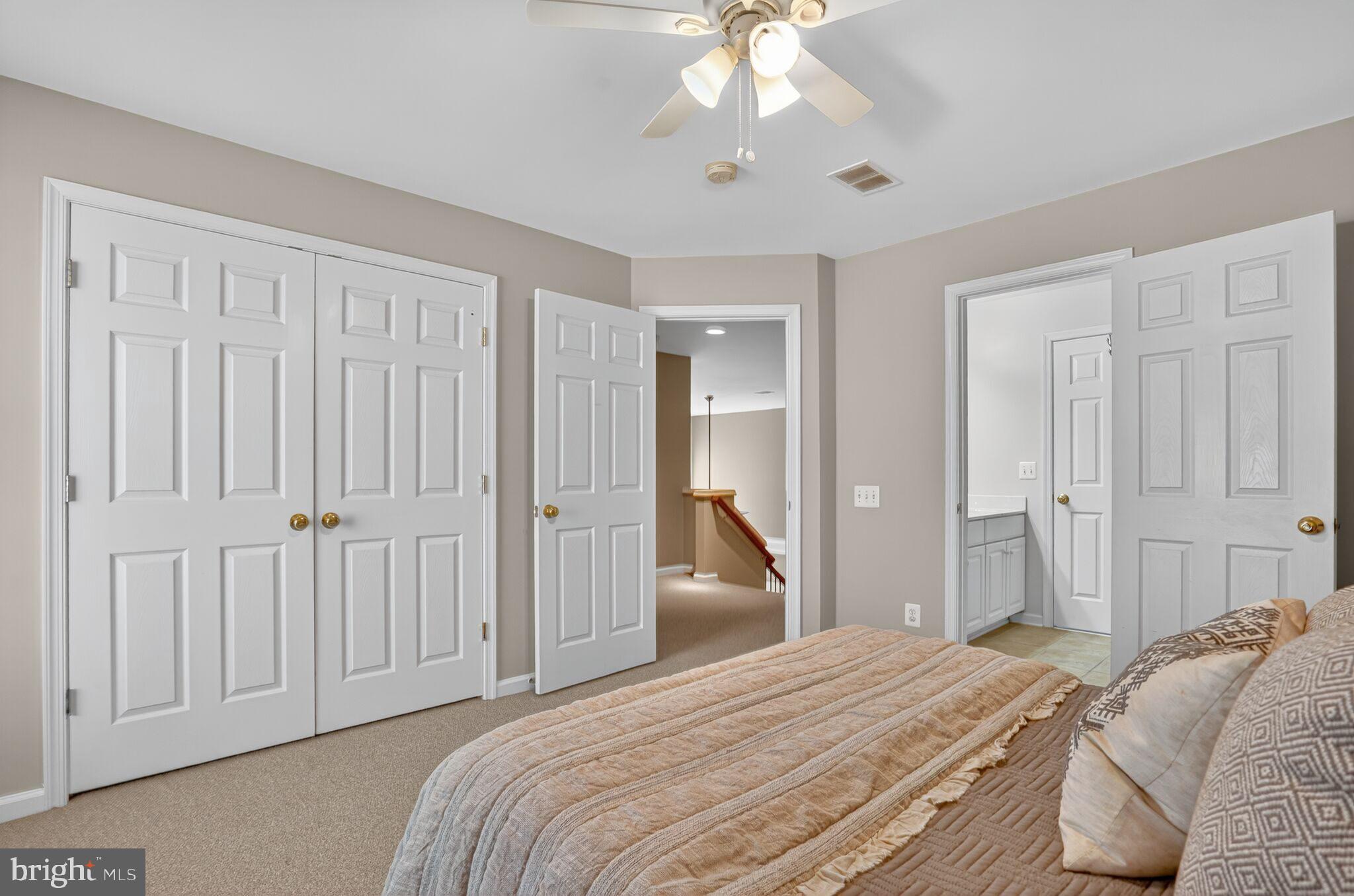 8157 American Holly Road Lorton, VA 22079 - Photo 33 of 48 a bedroom with a bed and a chandelier