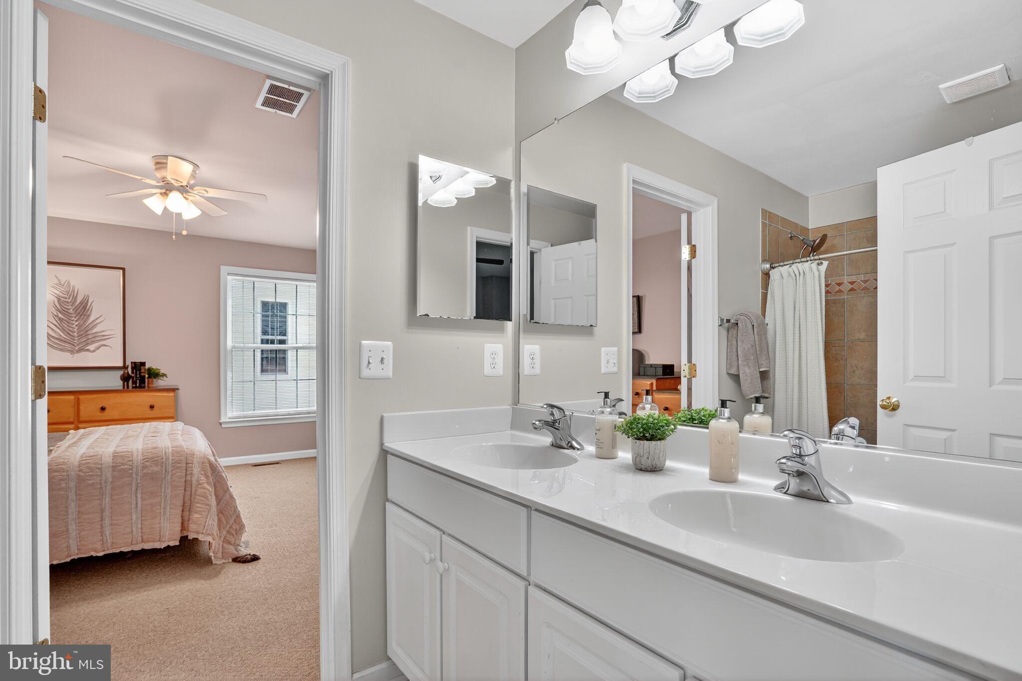 8157 American Holly Road Lorton, VA 22079 - Photo 34 of 48 a en suite bathroom with a double vanity sink and a mirror