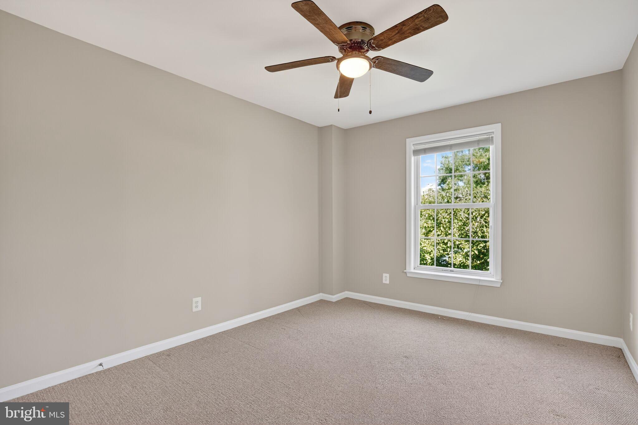 8157 American Holly Road Lorton, VA 22079 - Photo 36 of 48 an empty room with a window and a fan