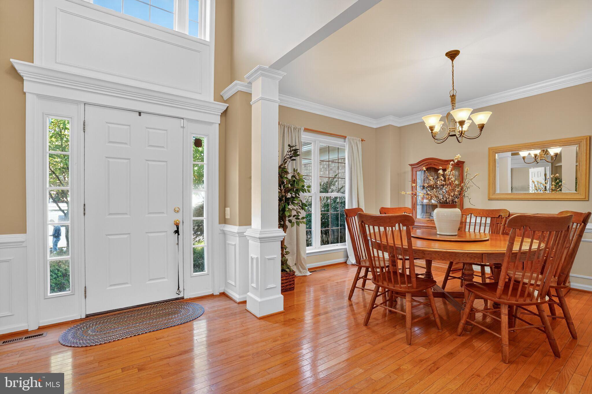 8157 American Holly Road Lorton, VA 22079 - Photo 4 of 48 a view of a dining room with furniture window and wooden floor