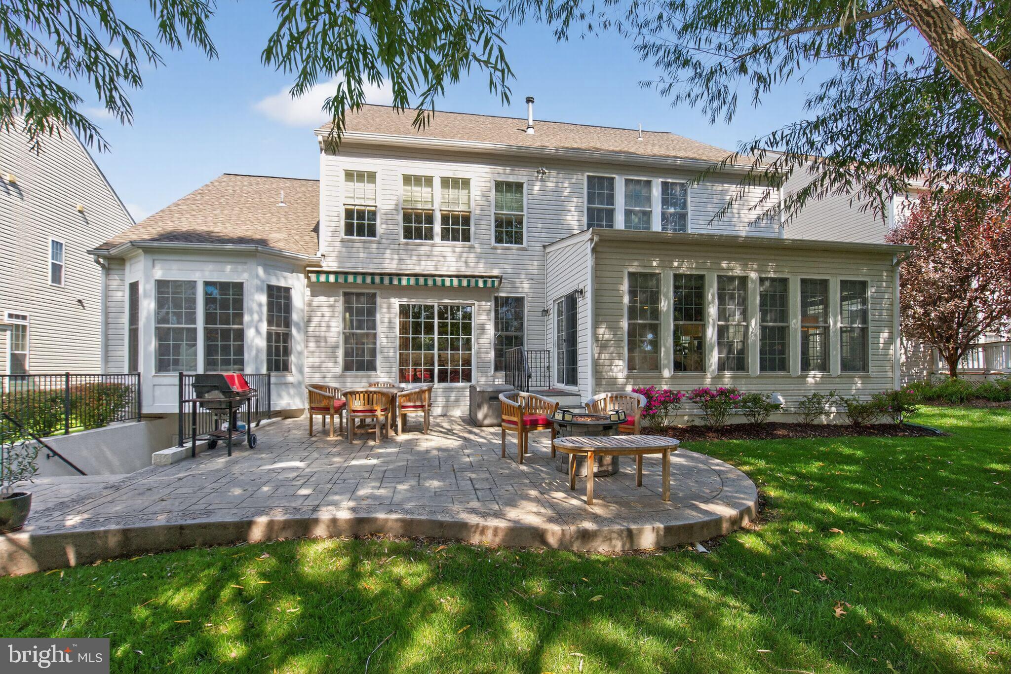 8157 American Holly Road Lorton, VA 22079 - Photo 46 of 48 a view of a house with a yard patio and fire pit
