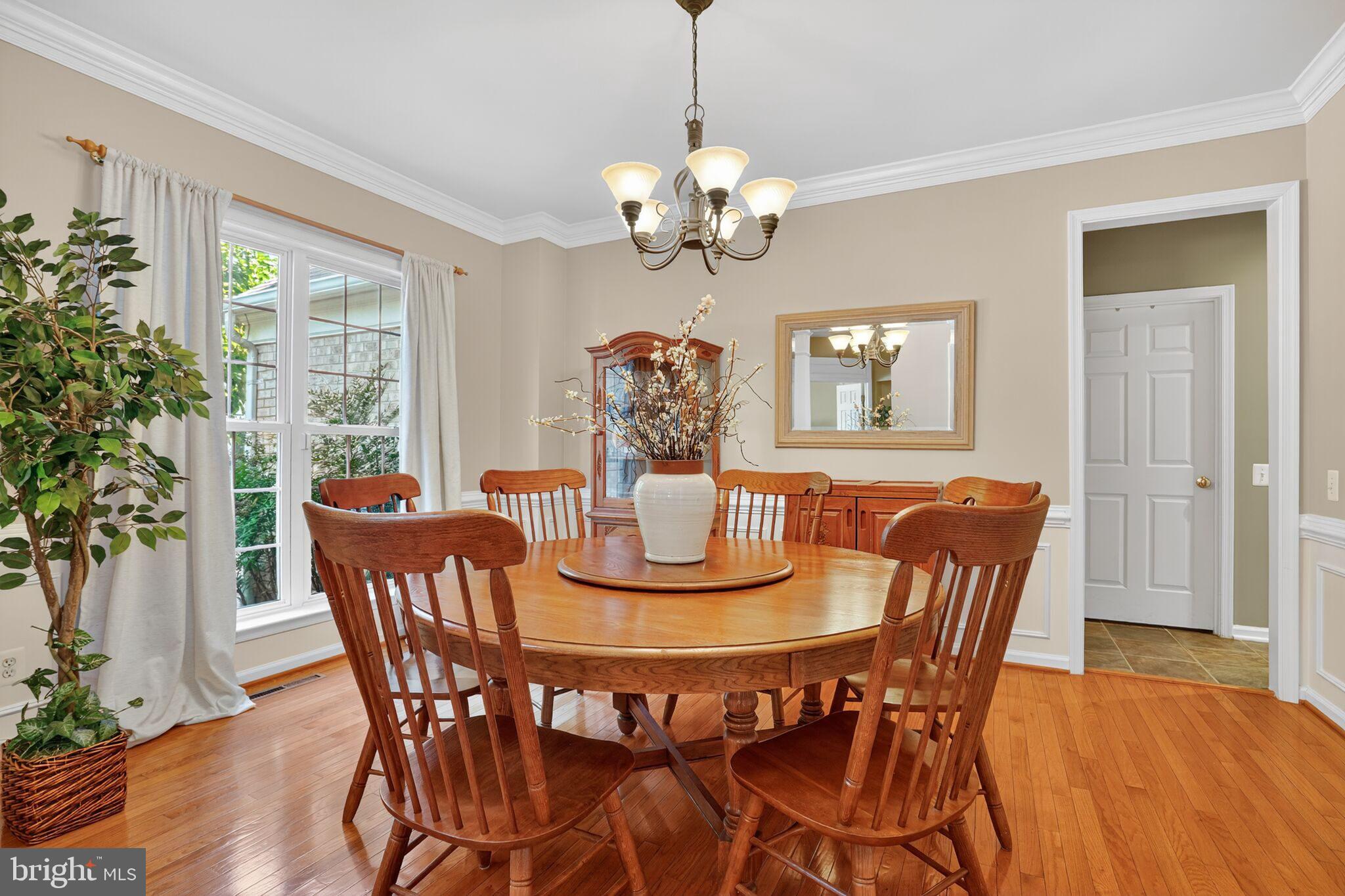8157 American Holly Road Lorton, VA 22079 - Photo 5 of 48 a view of a dining room with furniture wooden floor and chandelier