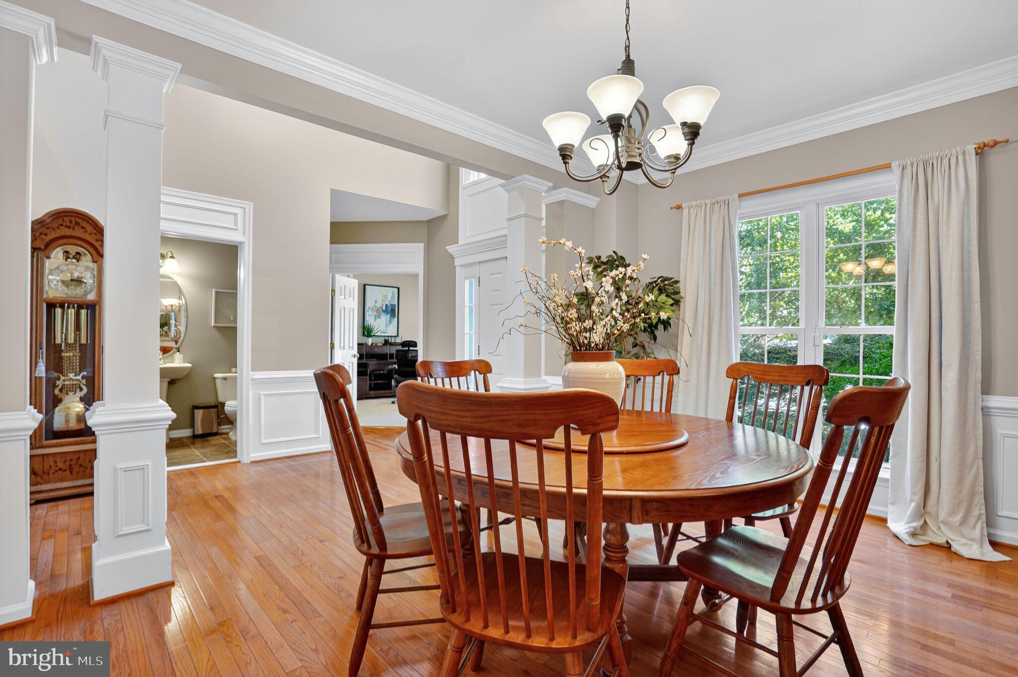 8157 American Holly Road Lorton, VA 22079 - Photo 6 of 48 a view of a dining room with furniture a chandelier and wooden floor