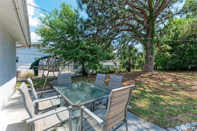 a view of a backyard with sitting area