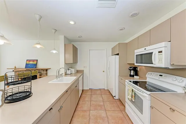 a large white kitchen with stainless steel appliances