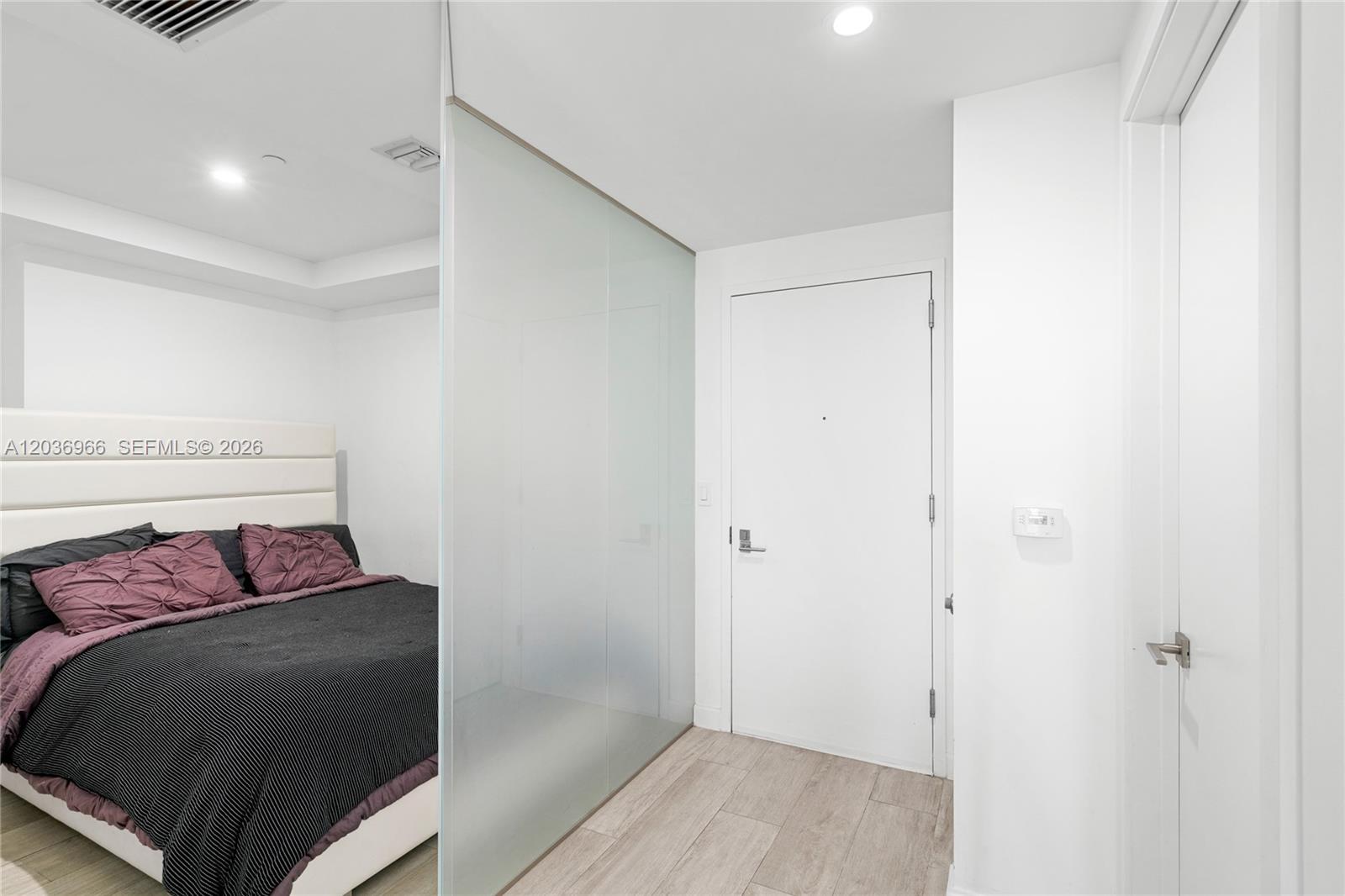 55 Southwest 9th Street, Unit 1904 Miami, FL 33130 - Photo 20 of 66 a bedroom with a bed and wooden floor