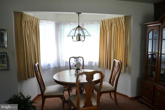 1209 Random Ridge Road Westminster, MD 21157 - Photo 7 of 12 a view of a dining room with furniture window and wooden floor