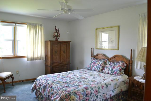 1209 Random Ridge Road Westminster, MD 21157 - Photo 10 of 12 a bedroom with a bed and a chandelier