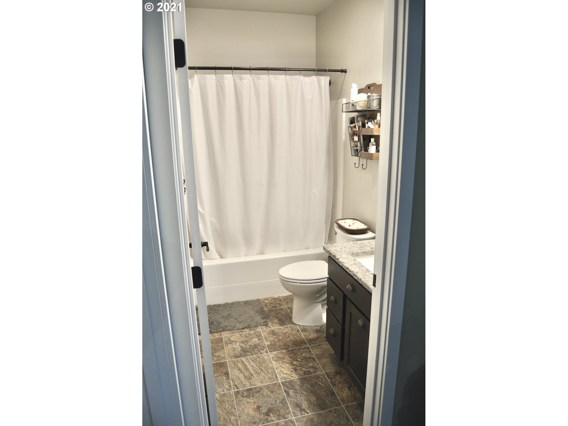 1820 Southwest 2nd Street Pendleton, OR 97801 - Photo 22 of 32 a bathroom with a granite countertop toilet and a shower