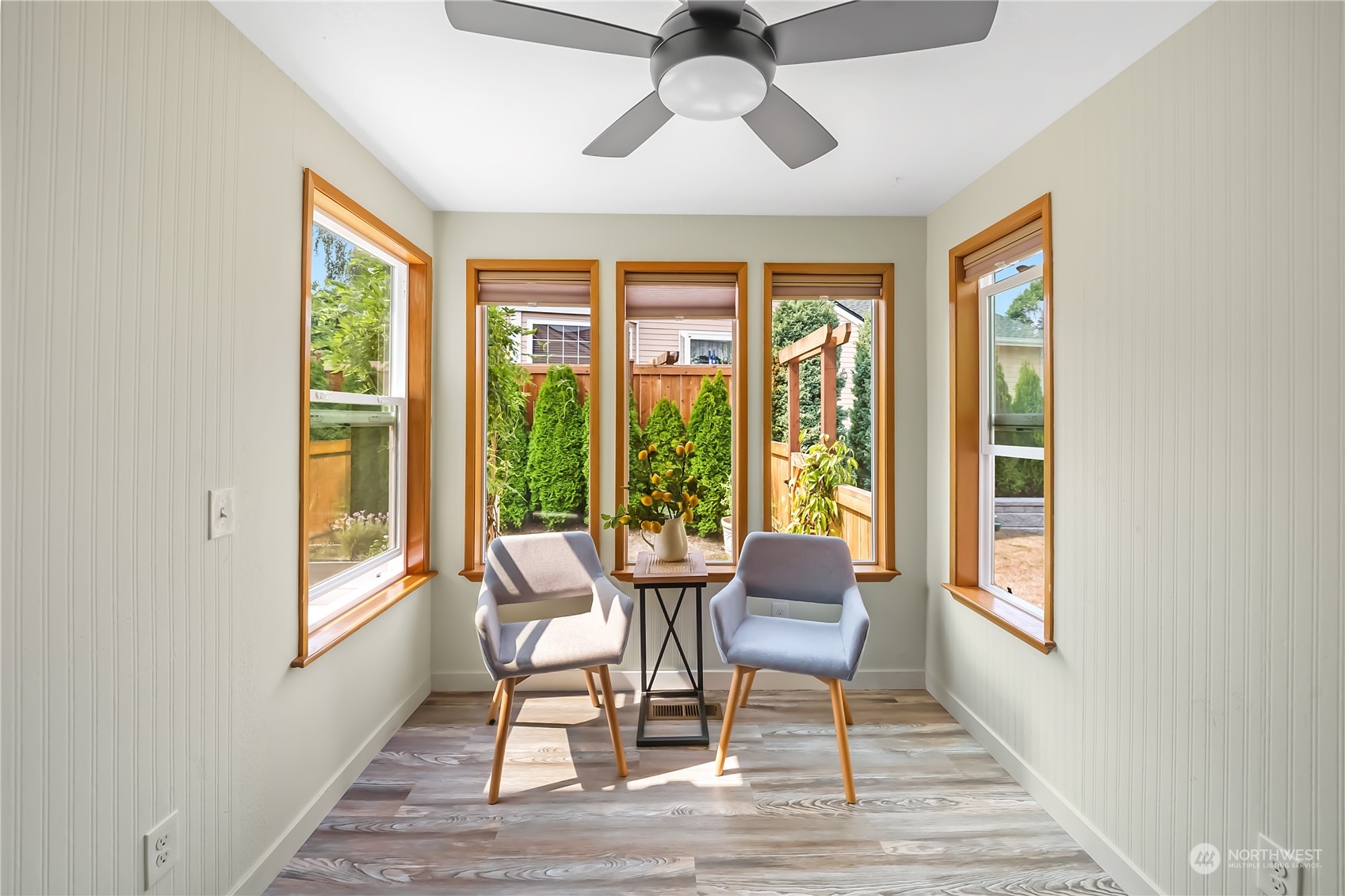1709 24th Court Anacortes, WA 98221 - Photo 12 of 33 a dining room with wooden floor a chandelier a glass table and chairs