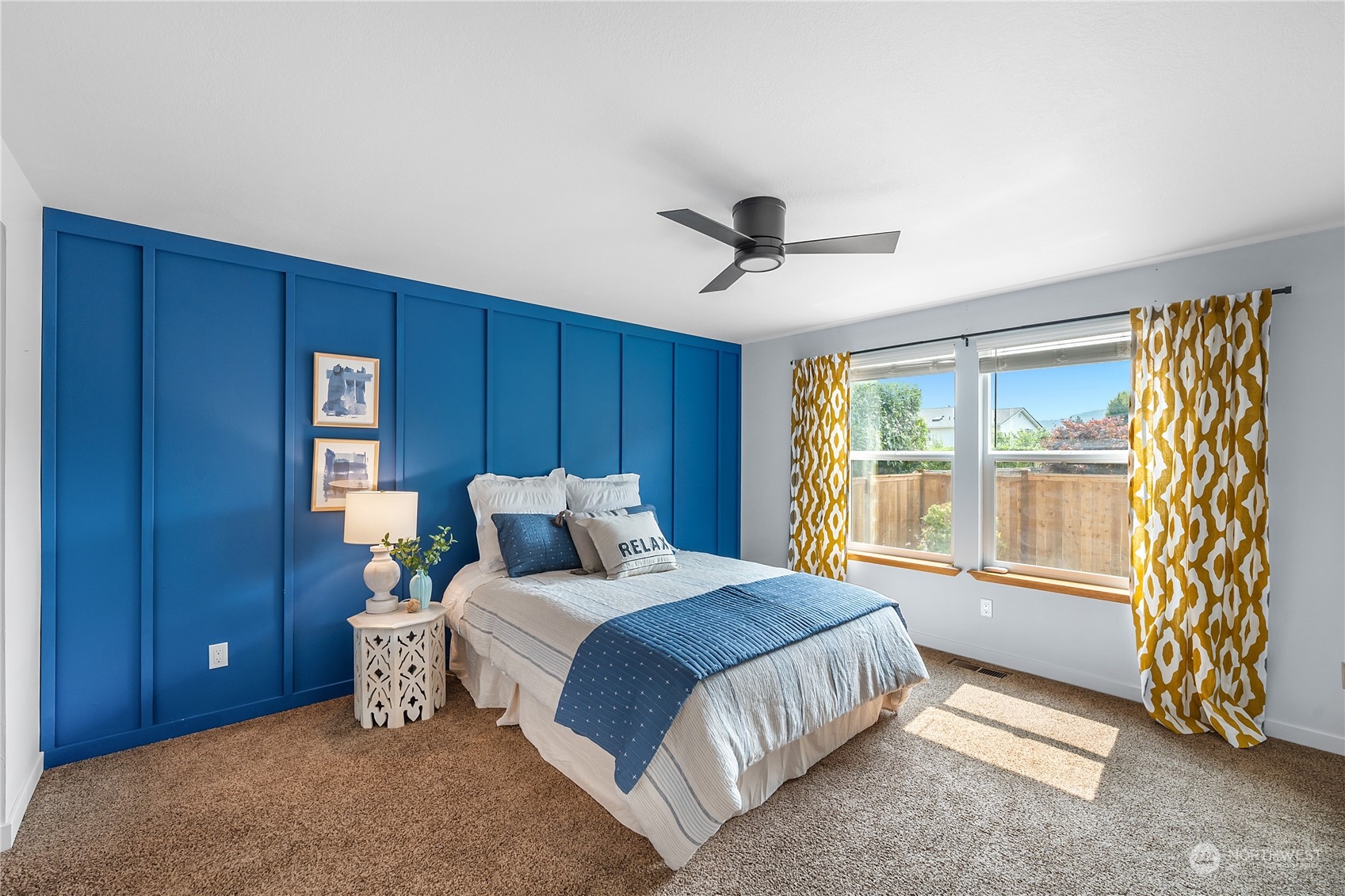 1709 24th Court Anacortes, WA 98221 - Photo 13 of 33 a bedroom with a large bed and a chandelier