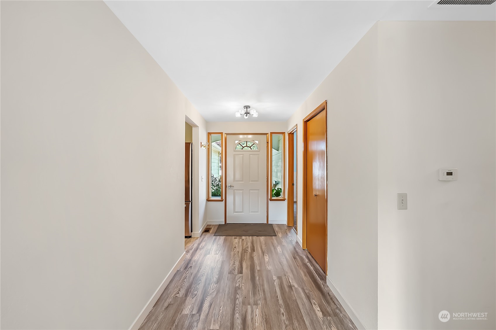 1709 24th Court Anacortes, WA 98221 - Photo 19 of 33 a view of a hallway with wooden floor and a bathroom