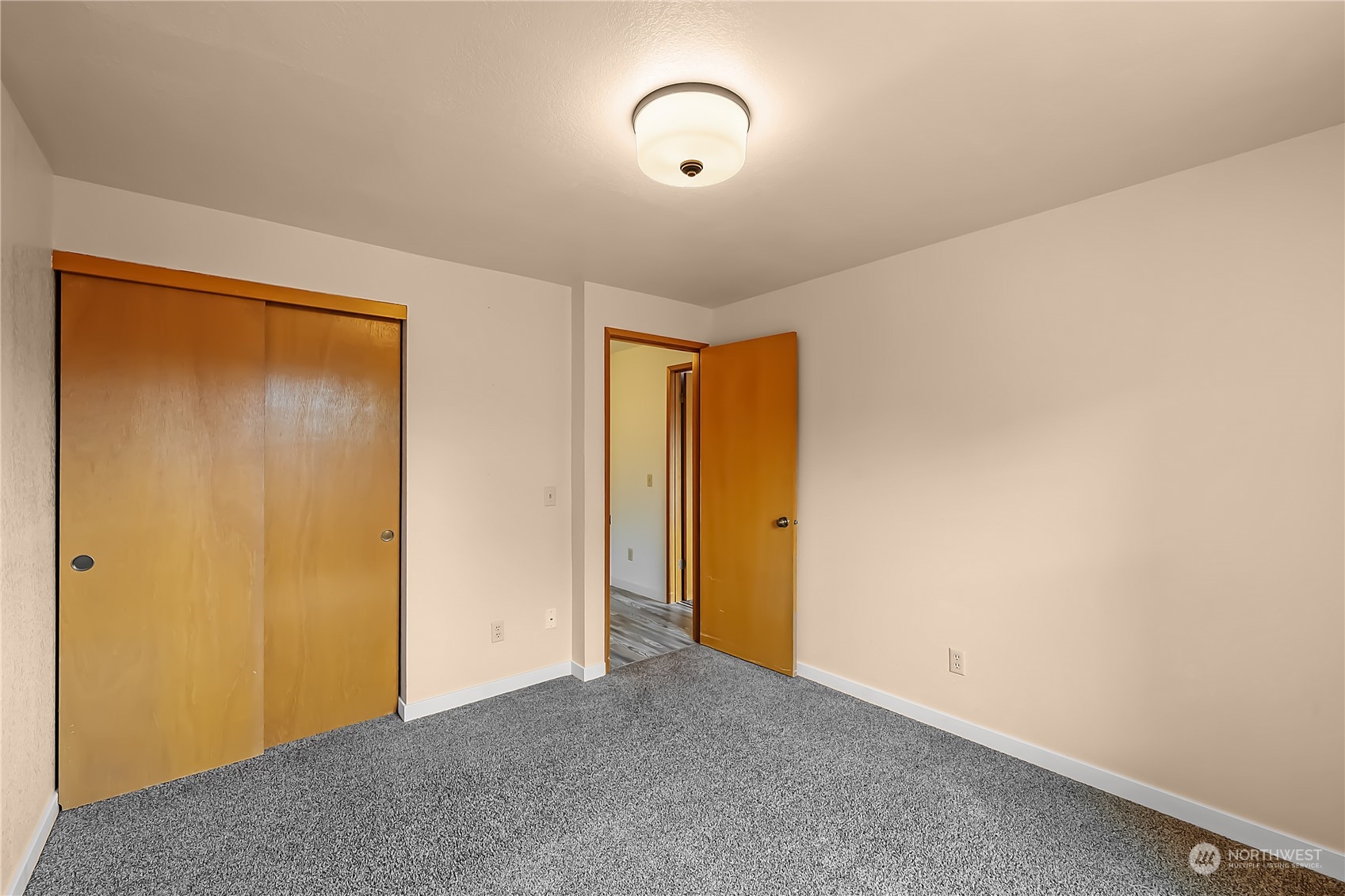 1709 24th Court Anacortes, WA 98221 - Photo 21 of 33 a view of an empty room with wooden floor