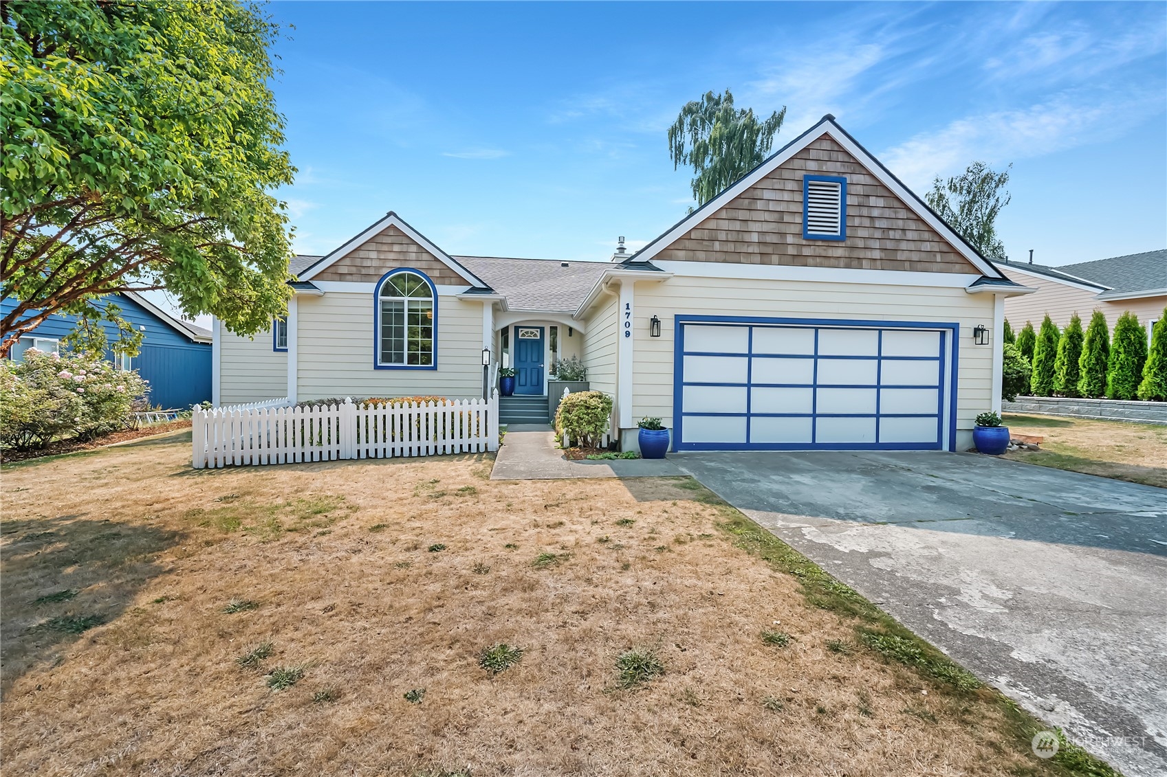 1709 24th Court Anacortes, WA 98221 - Photo 32 of 33 a front view of a house with a yard and garage