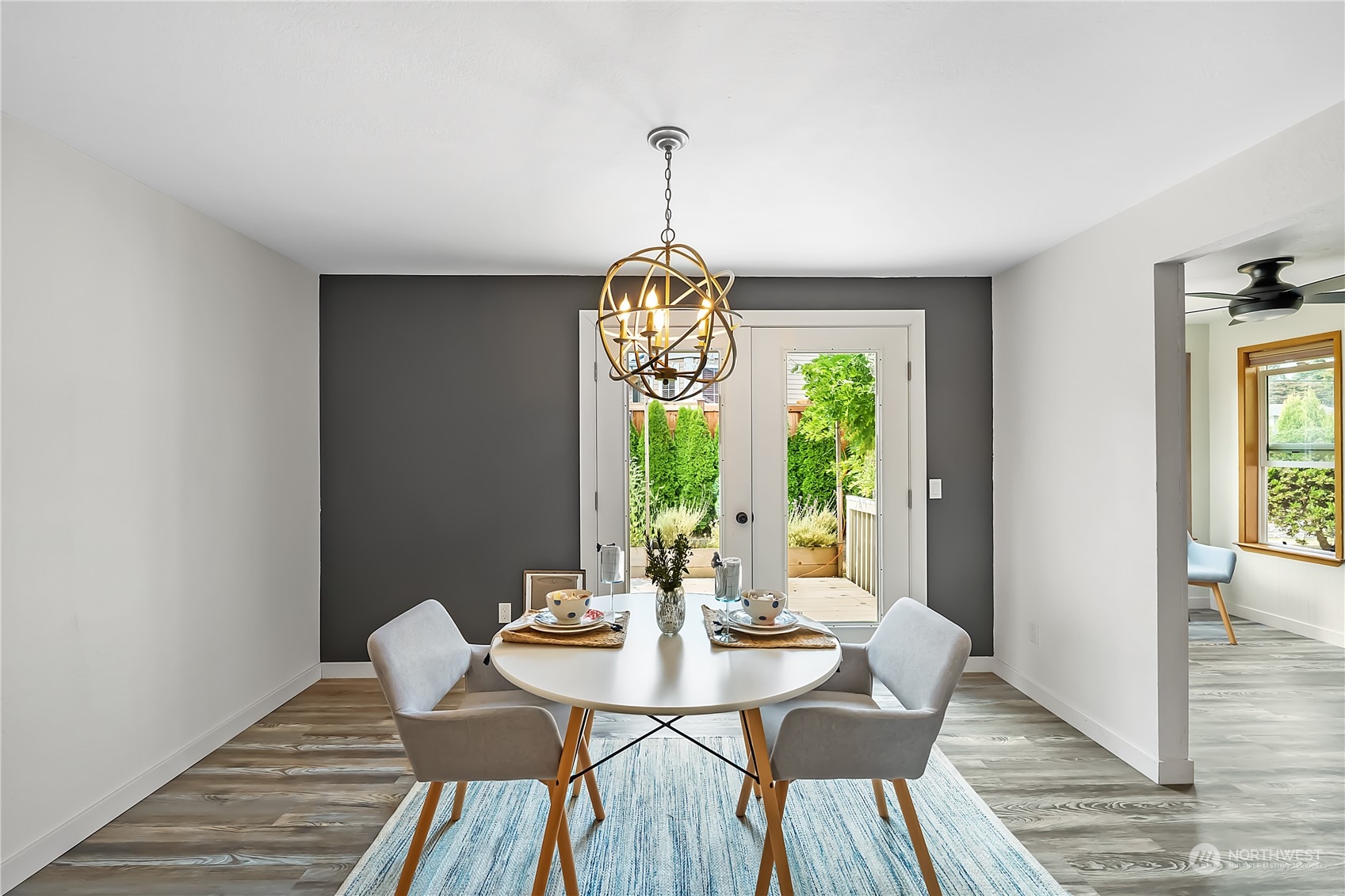 1709 24th Court Anacortes, WA 98221 - Photo 4 of 33 a dining room with furniture a chandelier and wooden floor