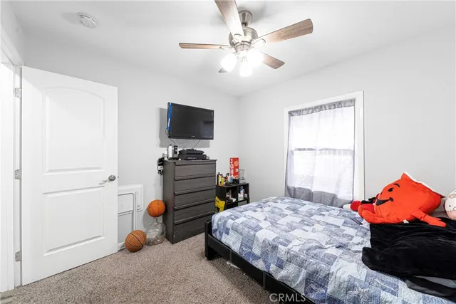 a bedroom with a bed and a tv