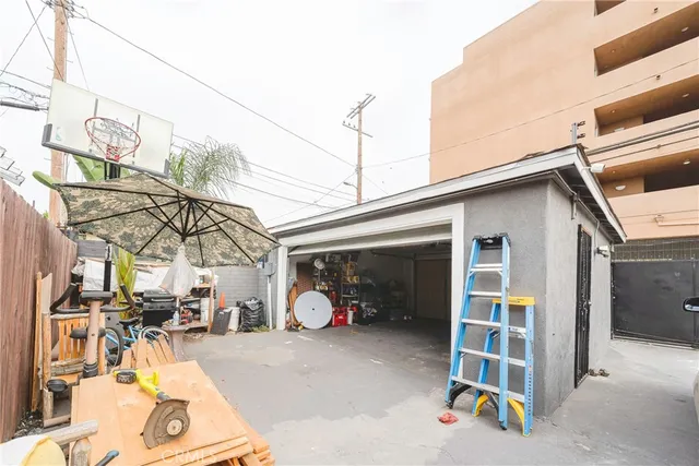 a view of a patio with table and chairs under an umbrella