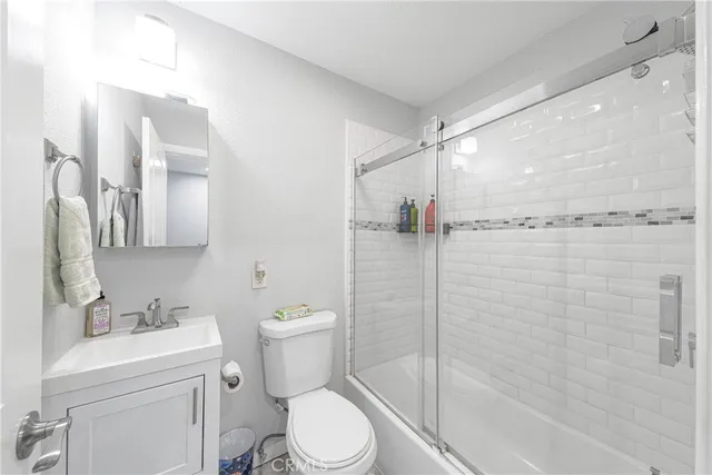 a bathroom with a toilet sink and shower