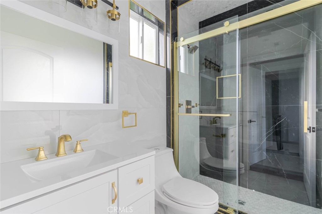 17428 Roscoe Boulevard Northridge, CA 91325 - Photo 12 of 24 a bathroom with a sink a toilet and shower