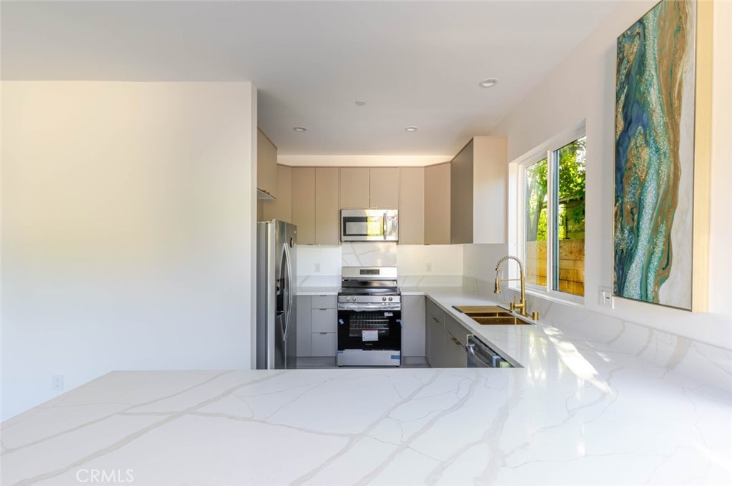 17428 Roscoe Boulevard Northridge, CA 91325 - Photo 13 of 24 a large kitchen with granite countertop a stove top oven