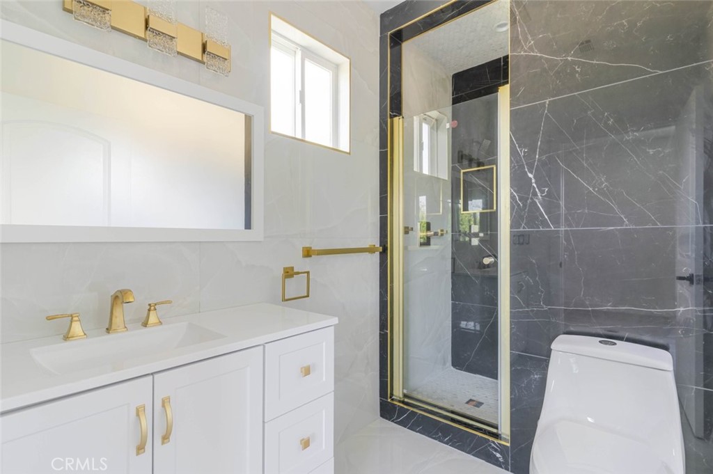 17428 Roscoe Boulevard Northridge, CA 91325 - Photo 21 of 24 a bathroom with a shower and mirror