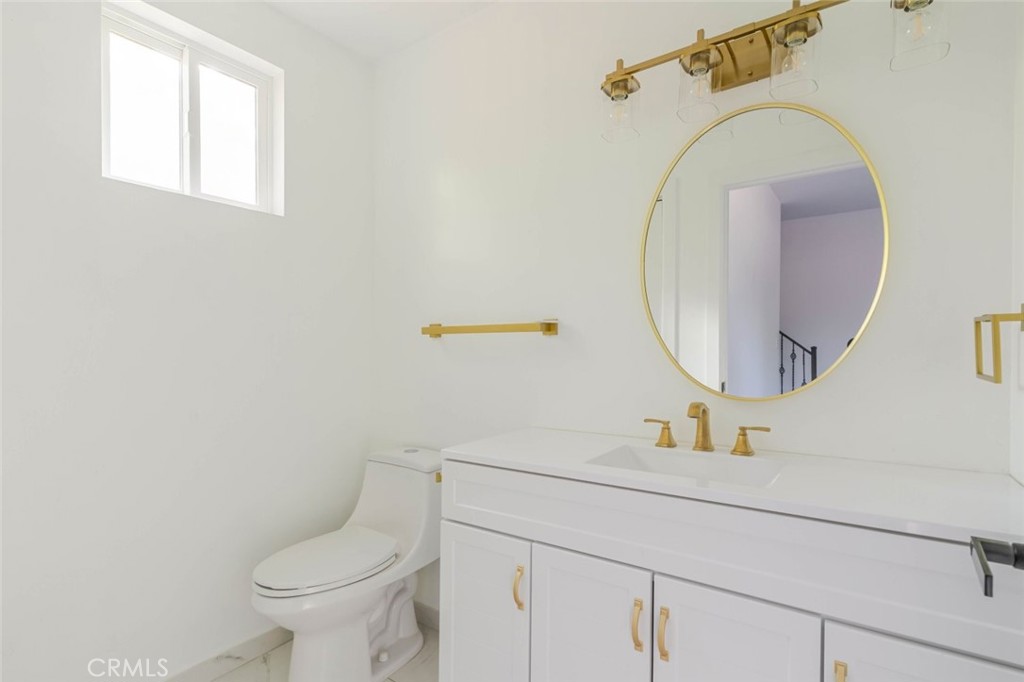 17428 Roscoe Boulevard Northridge, CA 91325 - Photo 23 of 24 a bathroom with a sink mirror and toilet