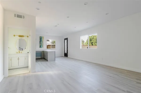 a kitchen with stainless steel appliances granite countertop a refrigerator stove and sink