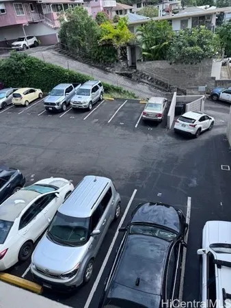 a view of a patio with lawn chairs and plants