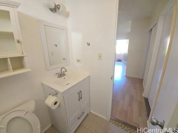 a bathroom with a sink mirror and toilet