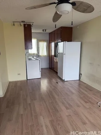 a kitchen with stainless steel appliances a refrigerator and wooden floor