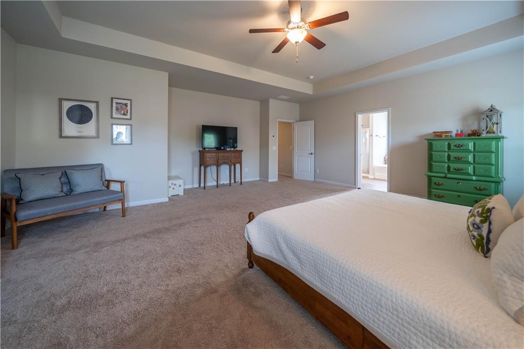 172 Mercer Lane Cartersville, GA 30120 - Photo 25 of 44 a spacious bedroom with a bed and a chandelier