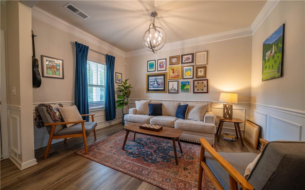 172 Mercer Lane Cartersville, GA 30120 - Photo 3 of 44 a living room with furniture a chandelier and a window