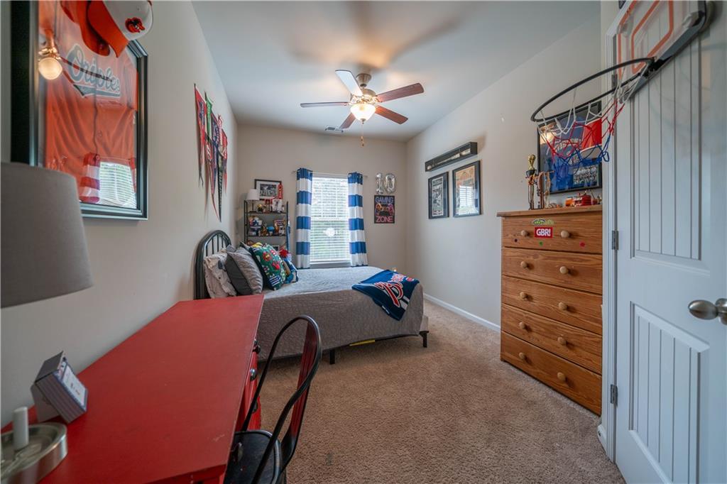 172 Mercer Lane Cartersville, GA 30120 - Photo 31 of 44 a bedroom with furniture and a chandelier
