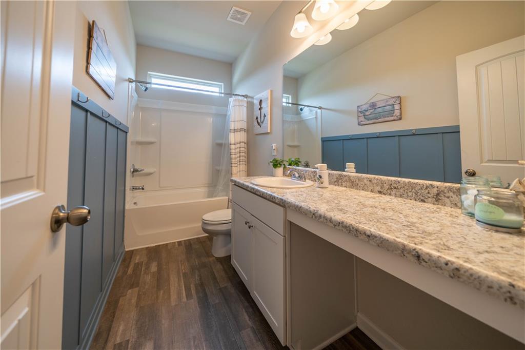 172 Mercer Lane Cartersville, GA 30120 - Photo 33 of 44 a bathroom with a granite countertop sink a toilet and a large mirror