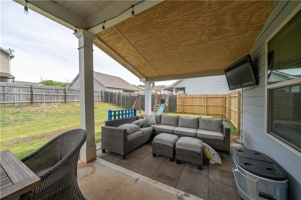 172 Mercer Lane Cartersville, GA 30120 - Photo 36 of 44 a balcony with furniture and a flat screen tv