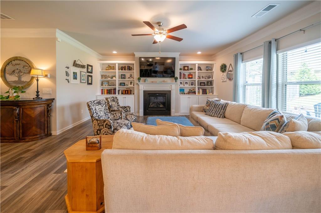 172 Mercer Lane Cartersville, GA 30120 - Photo 8 of 44 a living room with furniture a fireplace and a large window