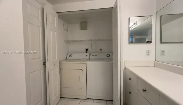 a utility room with cabinets washer and dryer