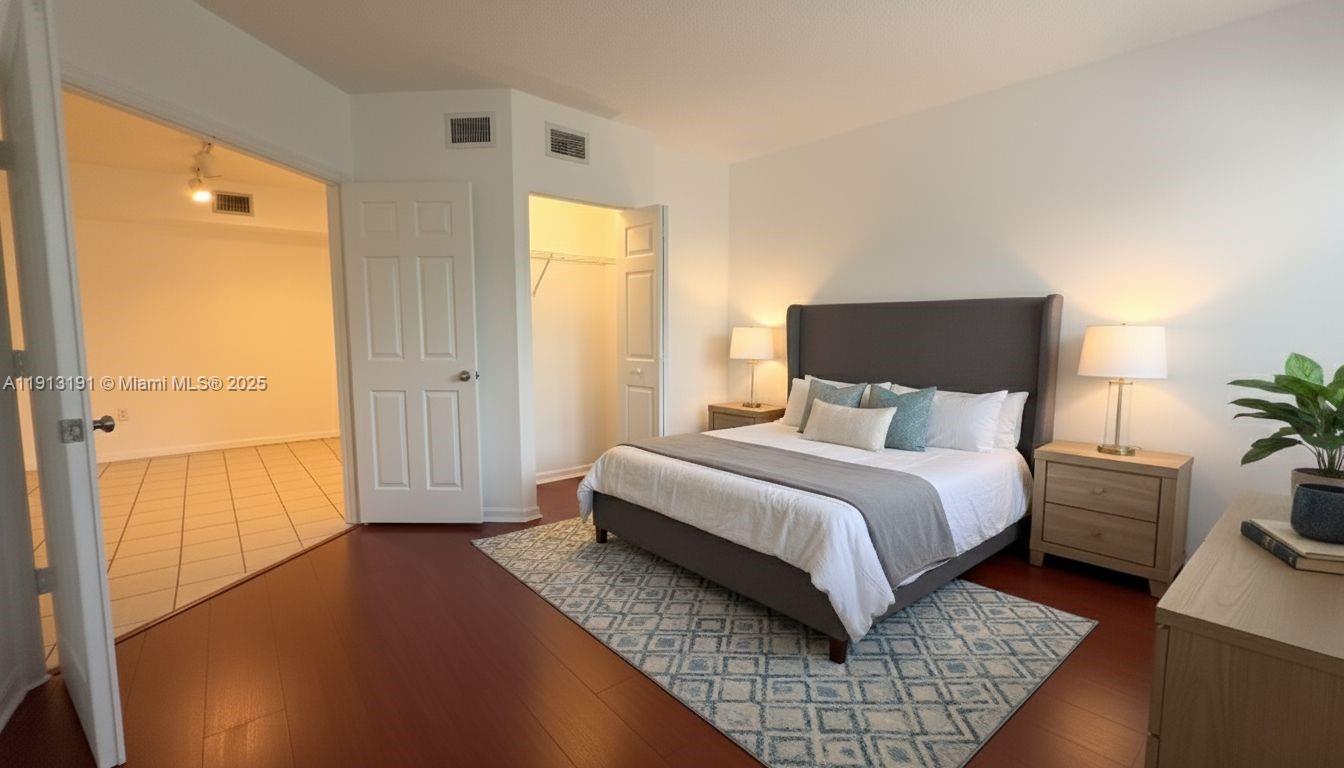 2120 West Preserve Way, Unit 307 Miramar, FL 33025 - Photo 9 of 20 a bedroom with a bed and wooden floor