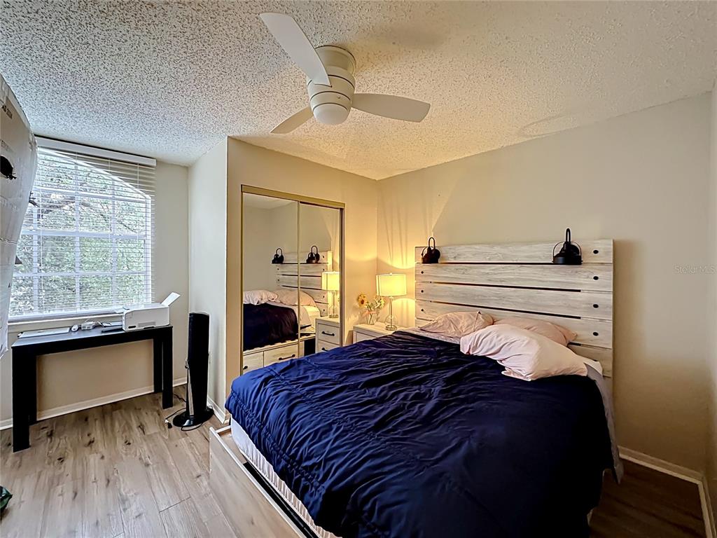 3705 Southwest 27th Street, Unit 922 Gainesville, FL 32608 - Photo 19 of 34 a bedroom with a bed and a fireplace